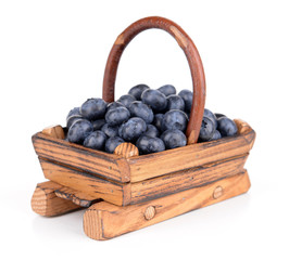 Delicious blueberries in wooden basket isolated on white