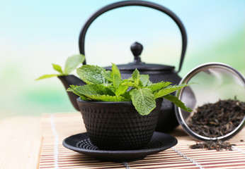 Chinese traditional teapot with fresh mint leaves