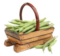 French beans in wooden basket isolated on white