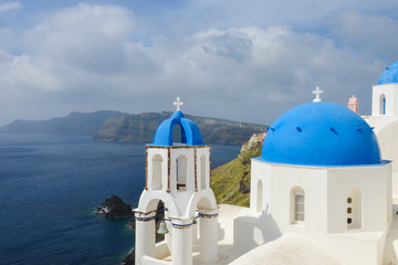 Naklejka premium Classic Santorini scene with famous blue dome churches