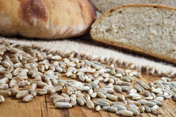 Fototapeta na wymiar wheat, rye and bread on wooden table, selective focus