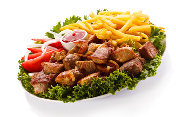 Grilled meat with French fries and vegetables
