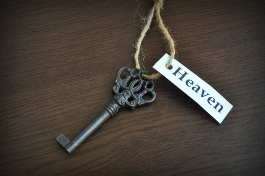 Key on the table with a note written on it key to heaven closeup