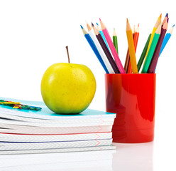 Naklejka premium notebooks, pencils and apple. Back to school concept.