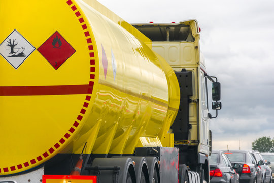 yellow fuel tank standing in a traffic jam