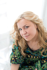Fototapeta premium Young attractive woman against the white curtains