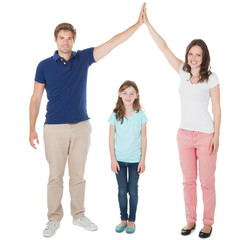 Fototapeta premium Parents Forming House Roof Shape Above Daughter