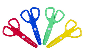 Art kit for children with colored plastic scissors on white