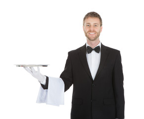 Smiling Young Waiter Holding Empty Serving Tray