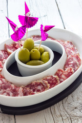 Appetizer of salami and olives