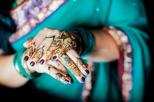 Hands painted with henna close up