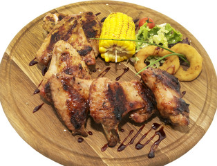 chicken wings with sweet corn on a wooden plate
