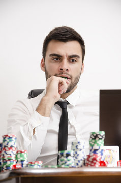 Nervous poker player biting chip