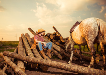 cowboy with horse at sunset lumbers