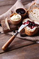 Fresh bread with homemade butter and blackcurrant jam