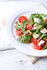 Salad with watermelon, feta, arugula and basil leaves