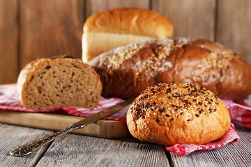 Composition of fresh baked bread, knife and kitchen towel,