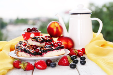 Sweet berry tart with berries on table on natural background
