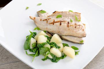 Grilled white fish fillets with potato and spinach