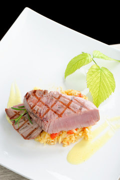 Fine dining / Medium rare sashimi tuna steak on saffron risotto