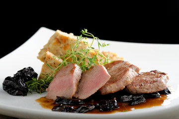 Venison steak cuts on a chestnut puree with dried plums