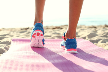 woman running on  the beach. closeup on shoe.