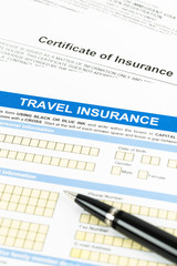 Travel insurance application form with pen