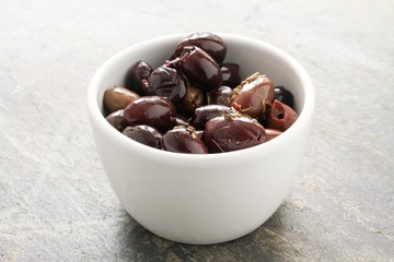 green and black olives in white dishes