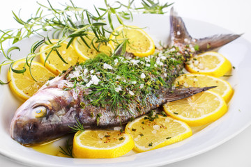 Seasoned bream fish on dish ready to cook