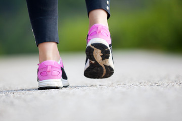 Plakat Runner feet running on road closeup on shoe
