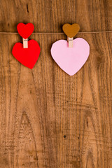 colorful paper heart hanging on wooden background