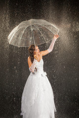 Bride sitting under rain