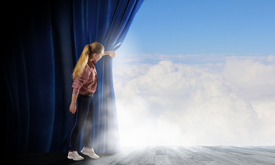 Woman looking out from curtain
