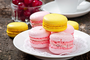 French colorful macarons on a wooden background