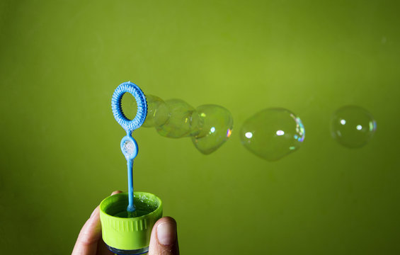 Bubble blower over green background
