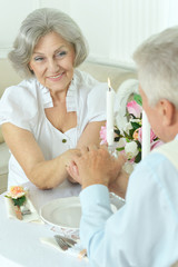 Obraz na płótnie Canvas Elderly couple having a dinner