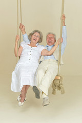 Elderly couple on swing