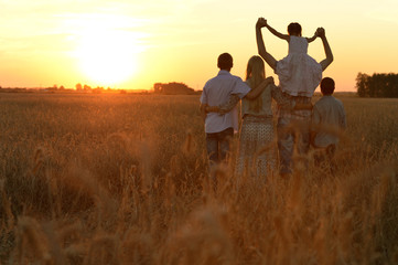 Family walking in field
