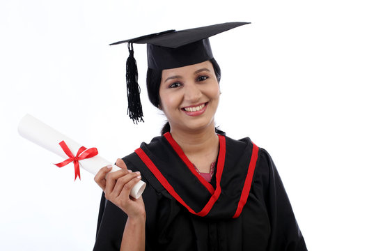 Happy young female student holding diploma