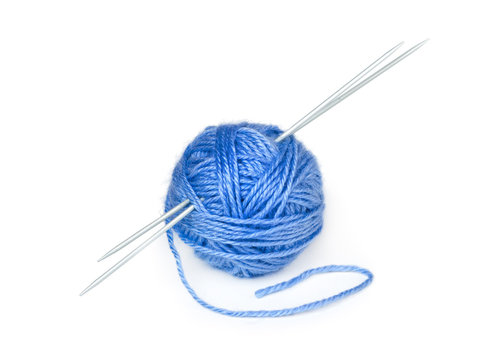 Clew of wool yarn with knitting needles