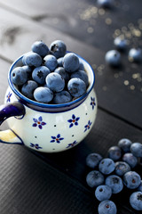 Fresh blueberries in a ceramic mug