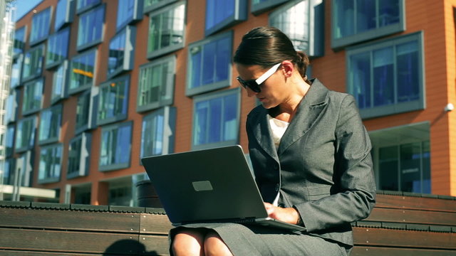 Businesswoman talking on cellphone about documents 