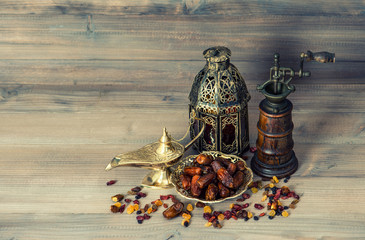 Fototapeta na wymiar Raisins and dates. Vintage oriental lantern and mill