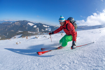Fototapeta na wymiar Skier against blue sky in high mountains