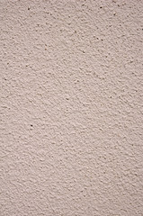 Light pink rough plaster on wall closeup