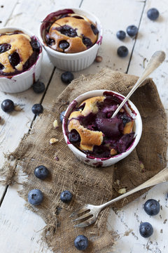 clafoutis with blueberries and cherries on rustic background
