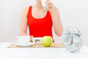 Schedule of the day. Morning. Woman having breakfast.