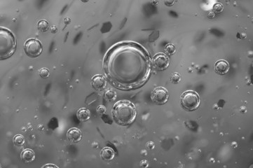 Air bubbles in a liquid. Abstract black-and-white background.