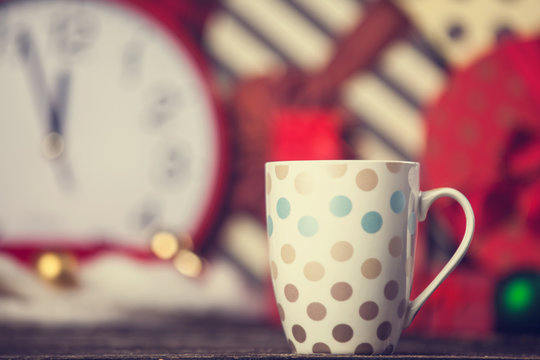Winter tea in a cup and christmas gifts on background.