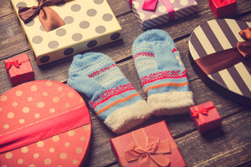 Mittens and christmas gifts around.